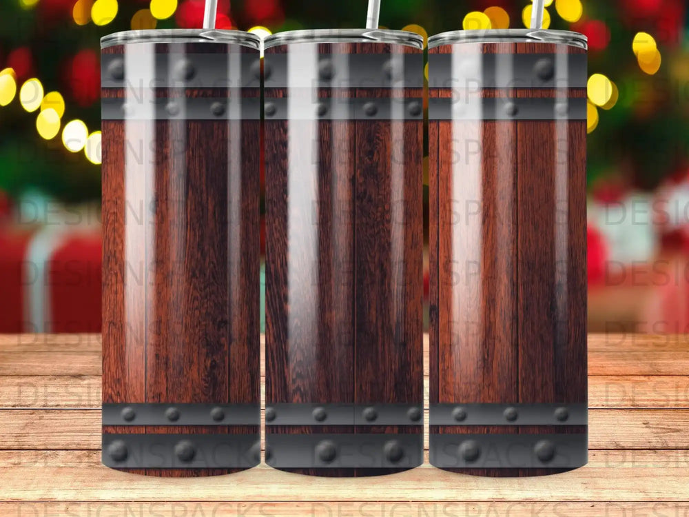 Three wooden barrel tumblers with metal bands, blurred festive background.