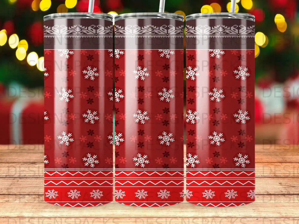 Red tumbler with snowflakes and festive borders, resembling a Christmas sweater.