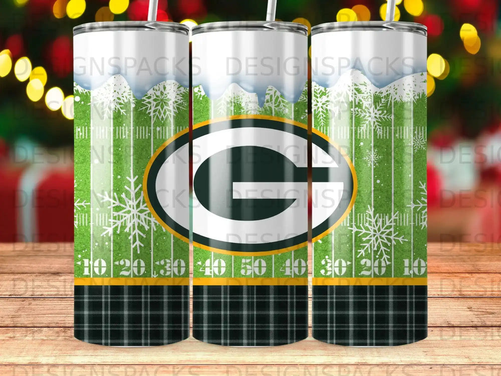 Green Bay Packers logo on a tumbler with plaid and snowflake background.