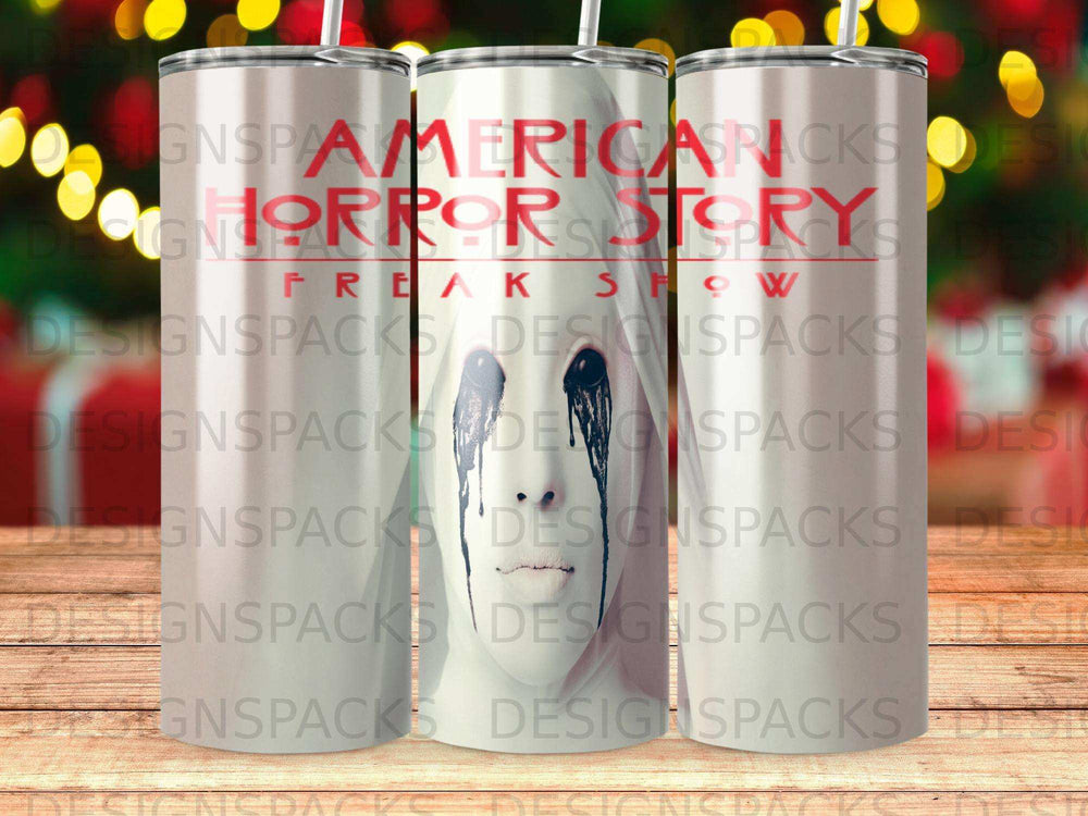 Tumbler with "American Horror Story Freak Show" design, featuring a distressed face.