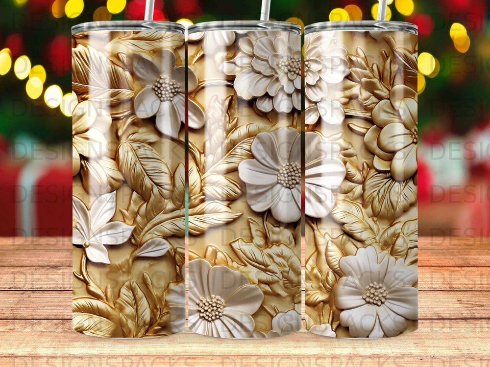 Gold tumbler with embossed white floral and leaf design.