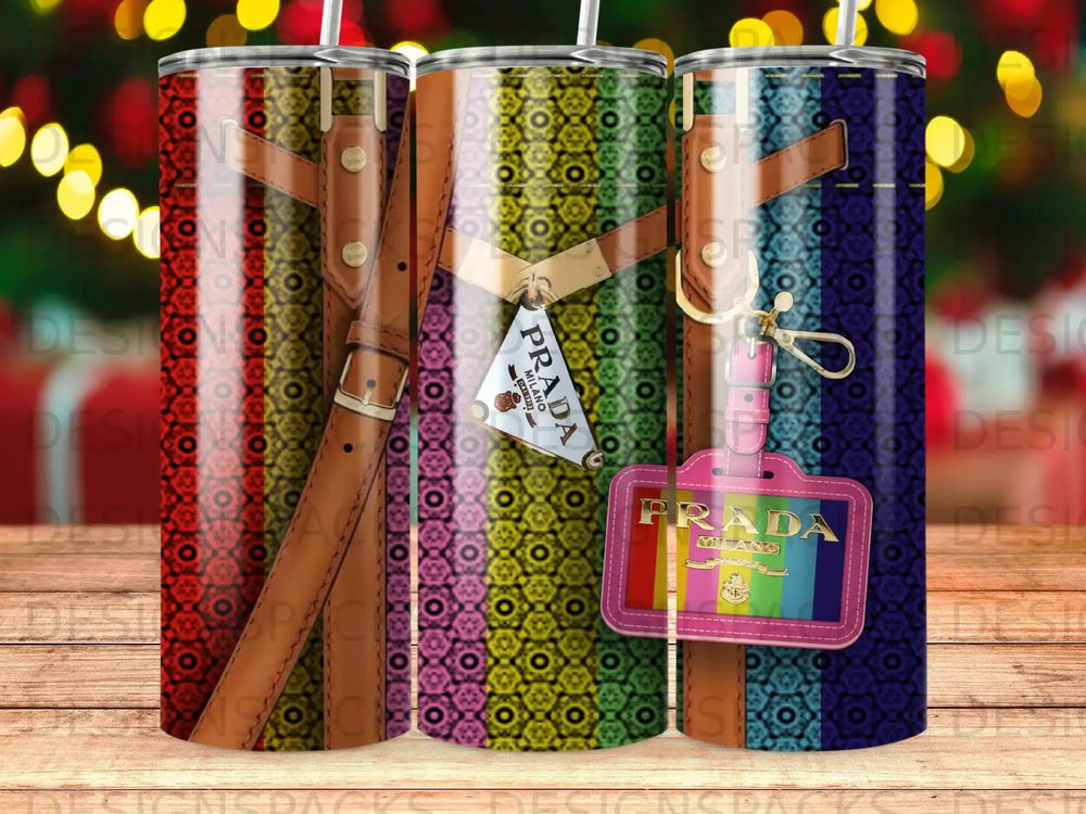 Three tall tumblers featuring a colorful striped pattern and Prada logos.