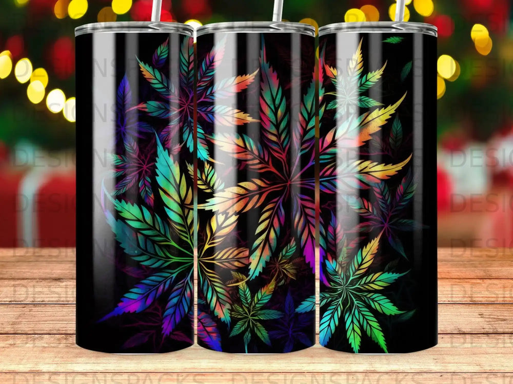 Colorful cannabis leaves on a black tumbler with bokeh lights in the background.