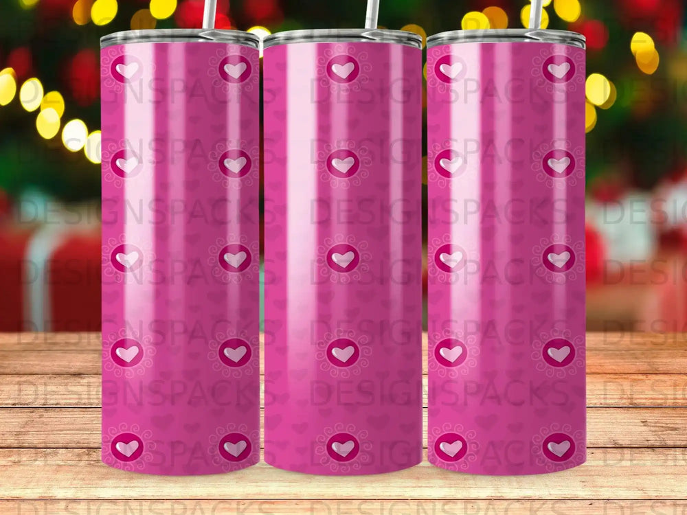 Pink tumbler with repeating heart pattern and "DESIGNSPACKS" watermark.