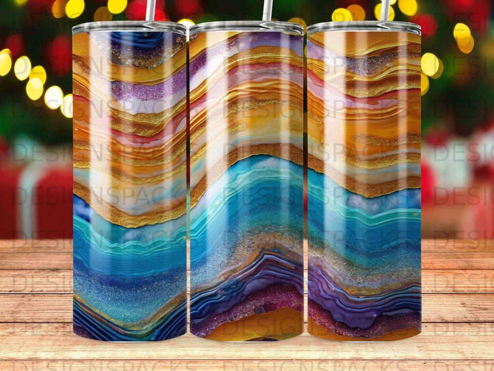Three tumblers with swirling agate-like patterns in blue, purple, gold, and orange.