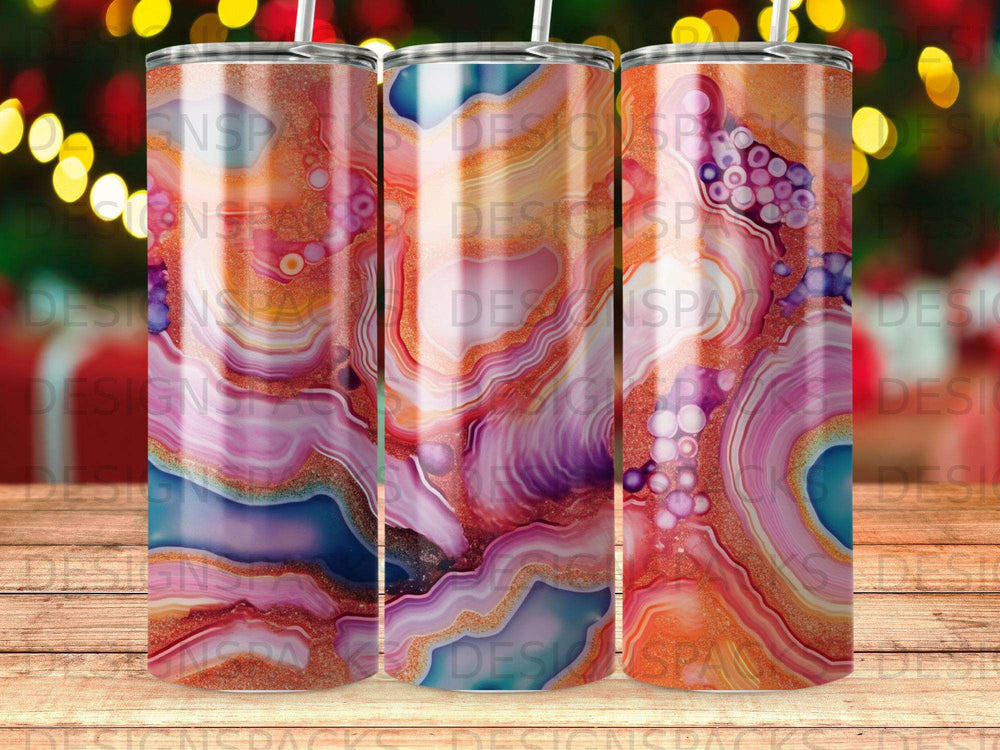 Abstract colorful marbled tumbler with gold glitter accents.