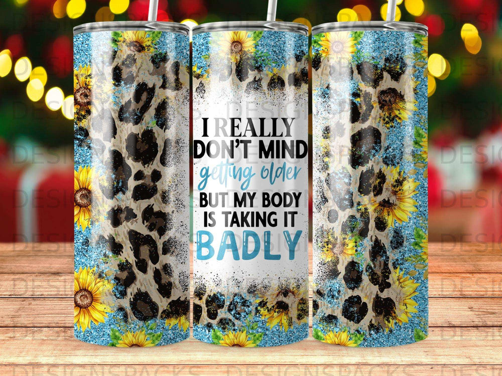 Tumbler with leopard print, sunflowers, and text "I really don't mind getting older but my body is taking it badly".