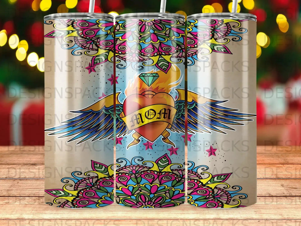 Tattooed heart with wings, "MOM" text, and colorful mandala design on a tumbler.