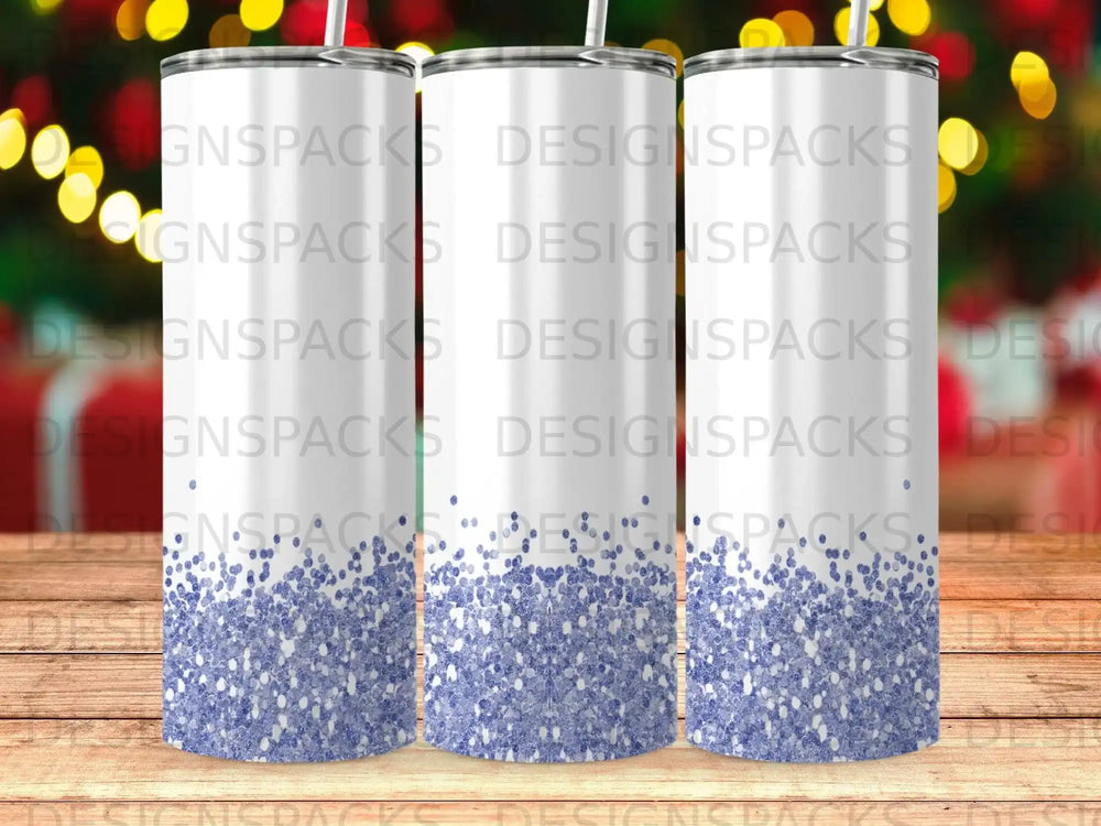 Three tumblers with a blue glitter design against a bokeh background.