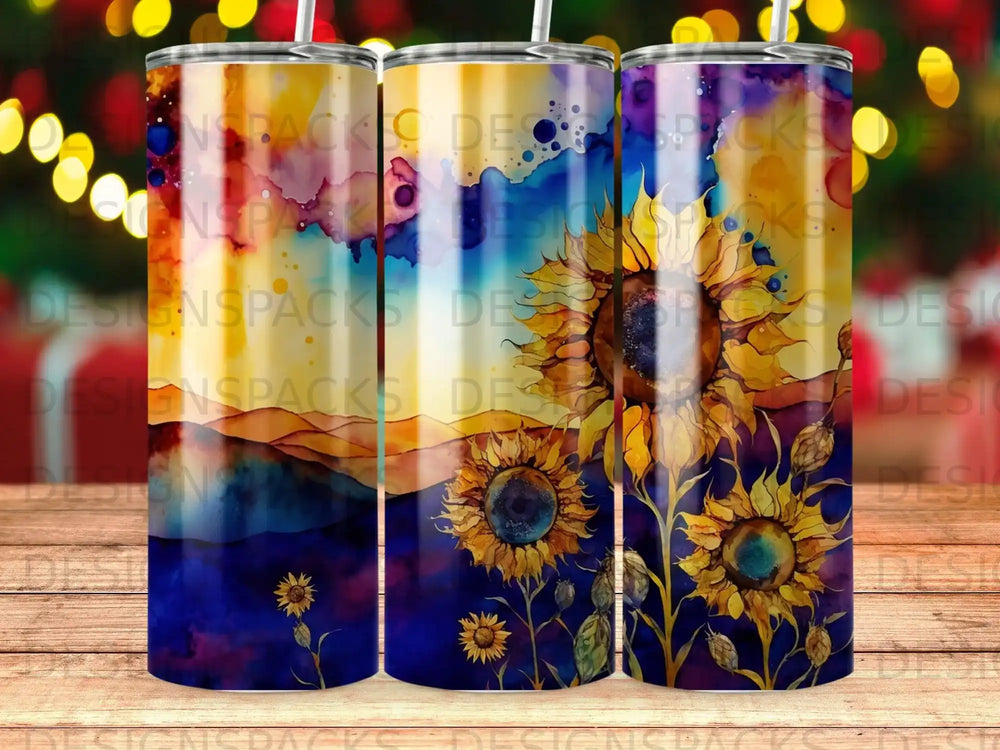 Three tumblers with sunflowers and a watercolor sunset design.