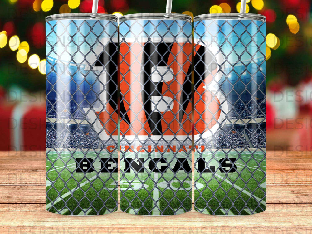 Cincinnati Bengals logo on a tumbler with a chain-link fence and stadium background.