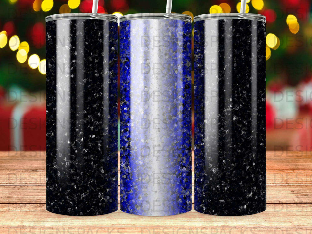 Three tumblers with a black and blue speckled design against a bokeh background.