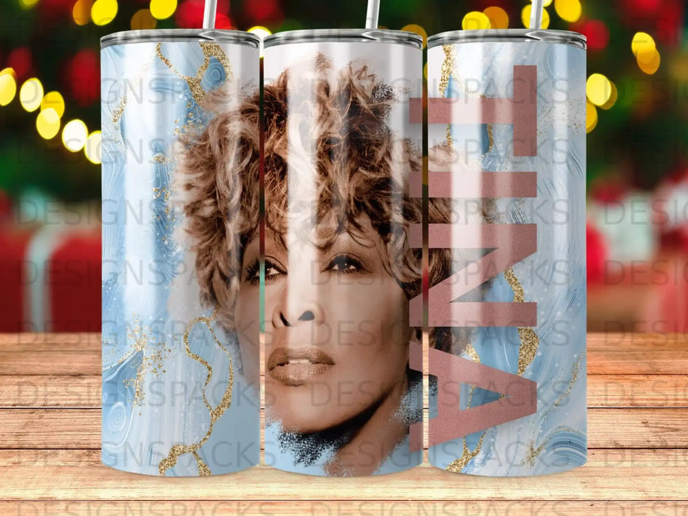 Tina Turner portrait on a blue marbled tumbler with glitter accents.