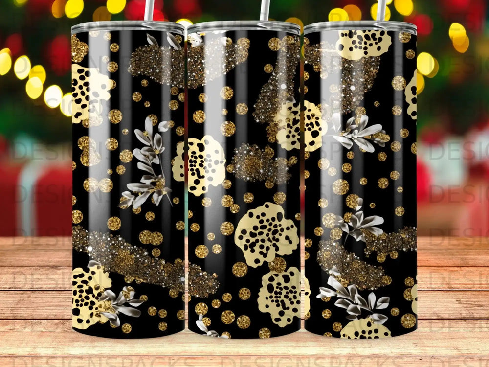 Black tumbler with scattered gold glitter and abstract floral pattern.