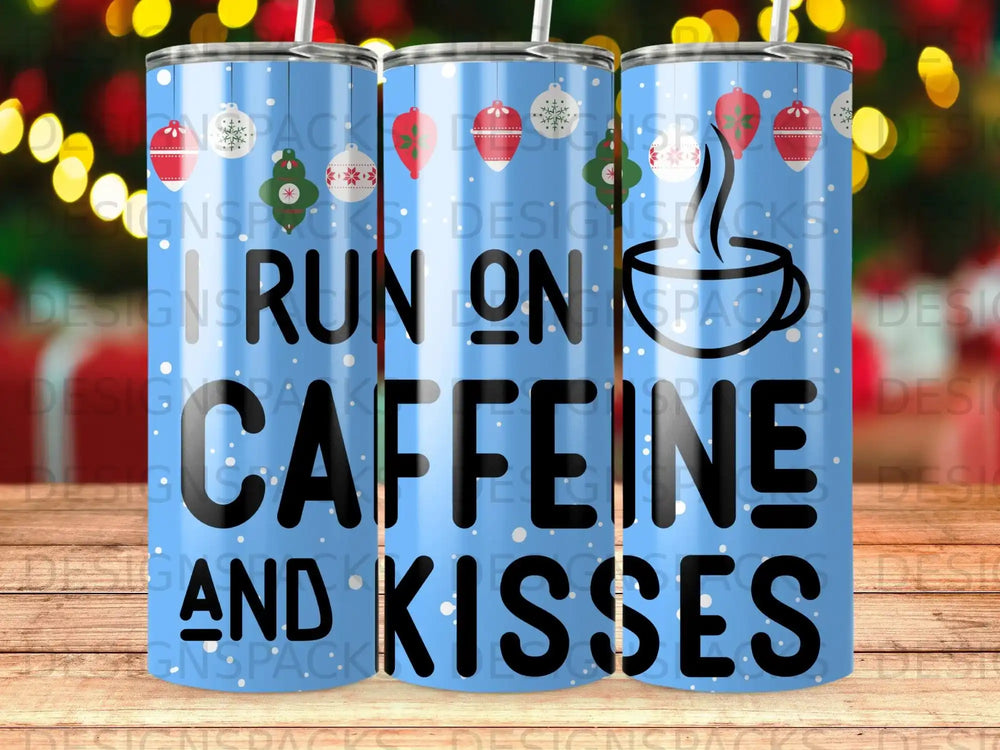 Blue tumbler with "RUN ON CAFFEINE AND KISSES" text and festive holiday accents.