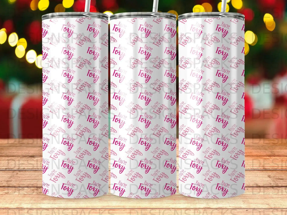 Three tumblers with a repeating "You're Foxy" pattern on a blurred background.