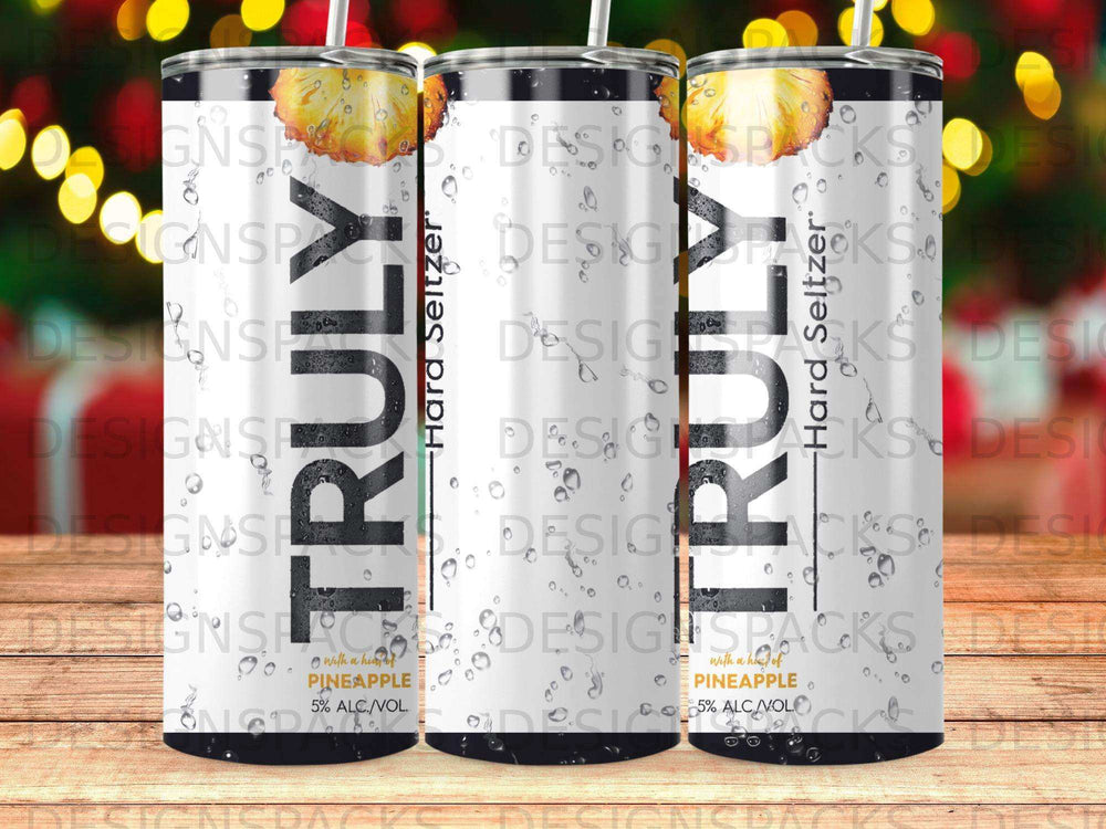 Three cans of TRULY Hard Seltzer with pineapple flavor and condensation.
