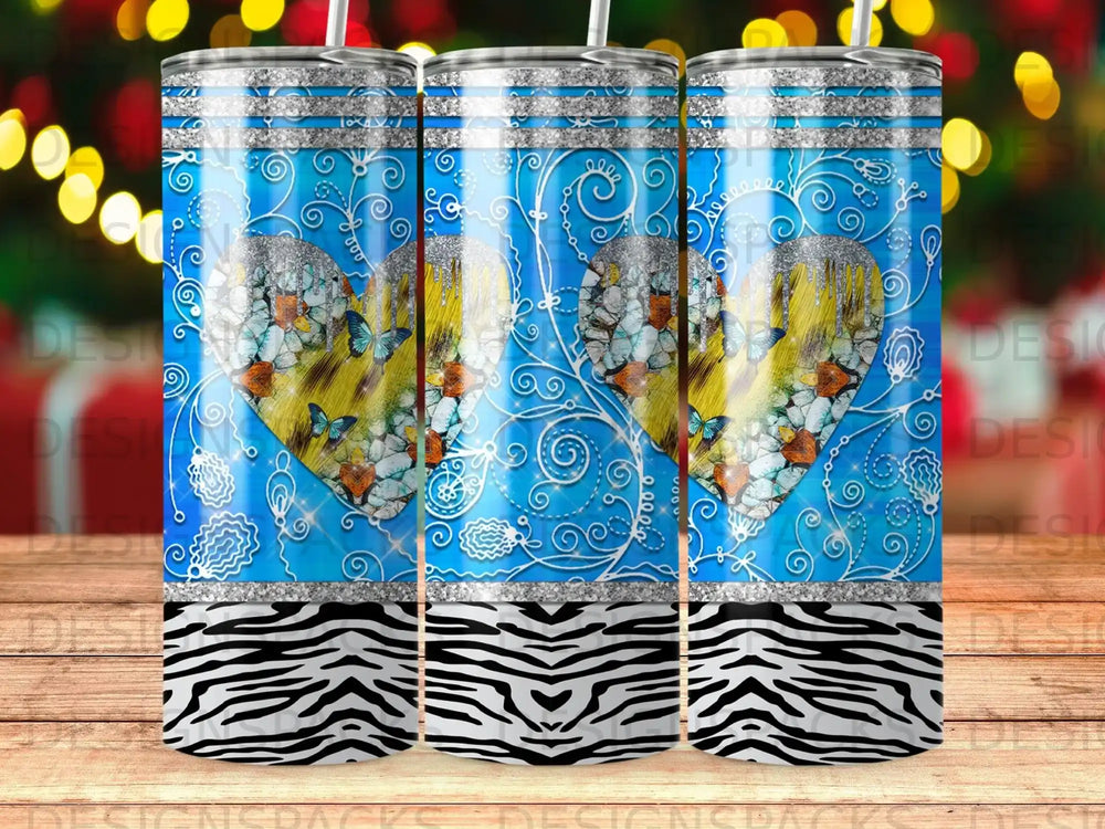 Blue tumbler with butterfly heart, glitter accents, and zebra print base.