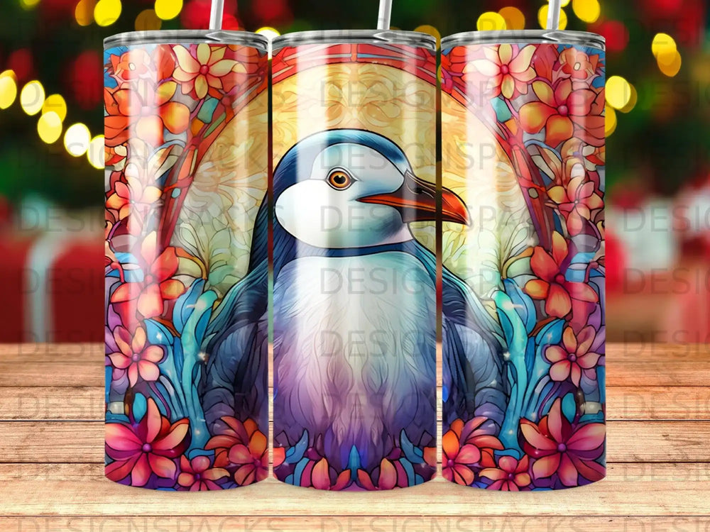 Penguin surrounded by colorful floral stained glass pattern on a tumbler.