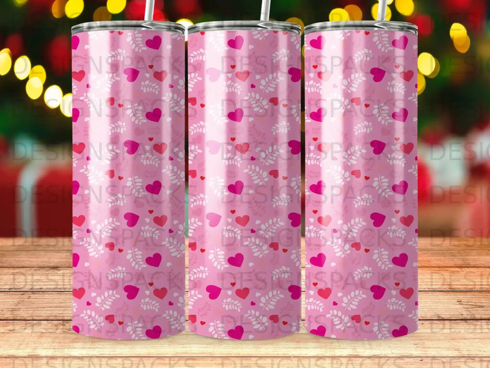 Pink tumbler with repeating heart and leaf pattern.