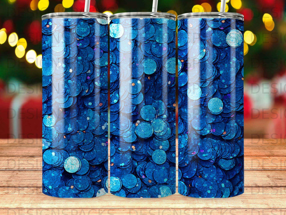 Tumbler with iridescent blue glitter design against a blurred bokeh background.