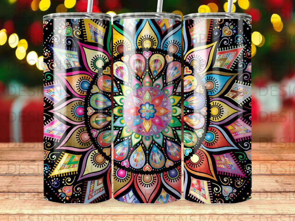 Colorful mandala pattern on a set of three tumblers with blurred bokeh lights background.