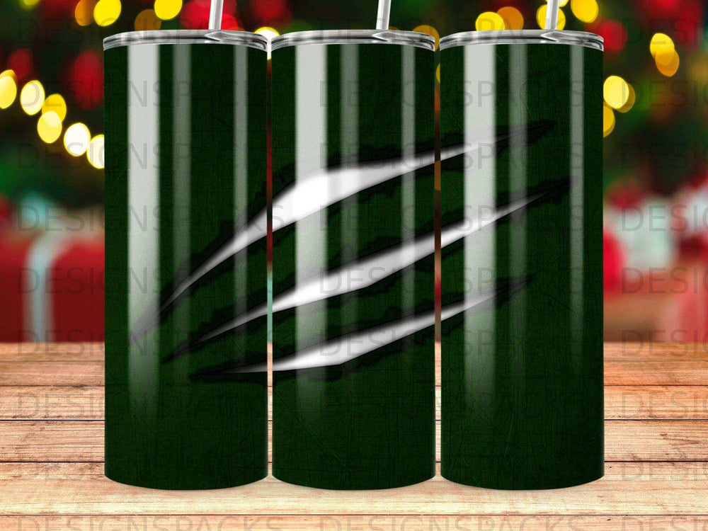 Dark green tumbler with scratched claw marks and blurred holiday lights.