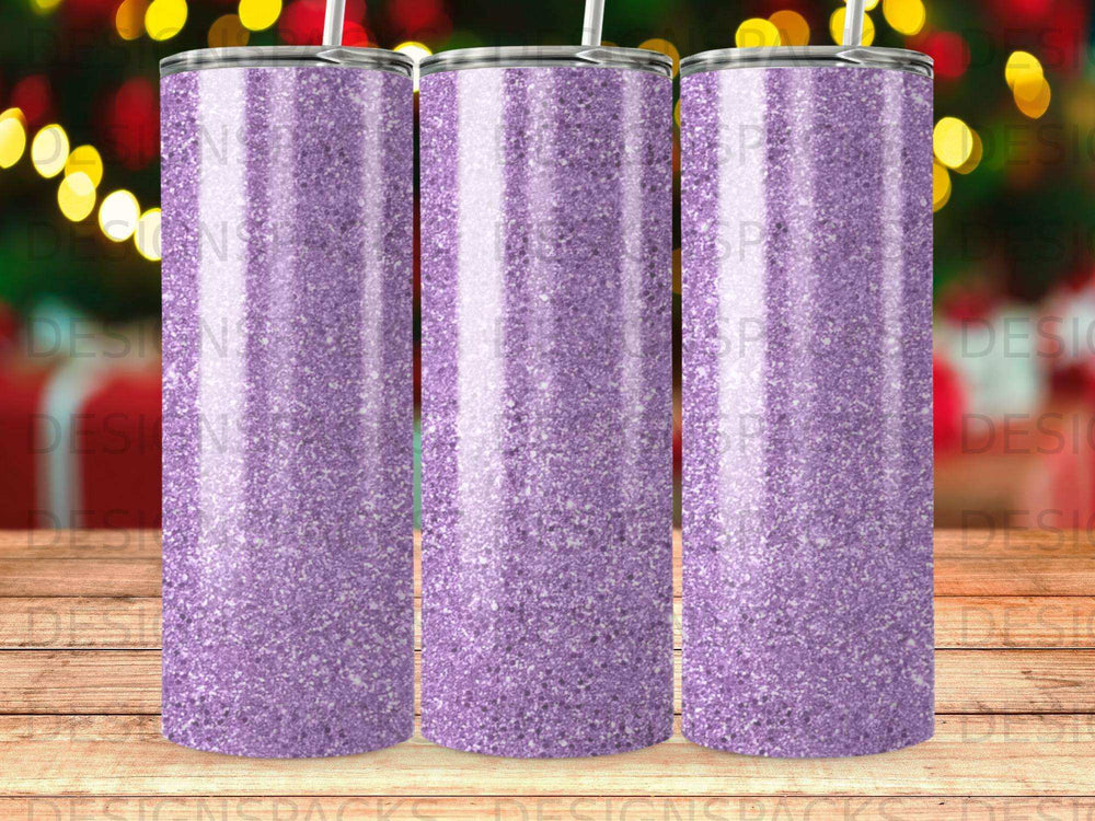 Three purple glitter tumblers with white straws against a blurred background.