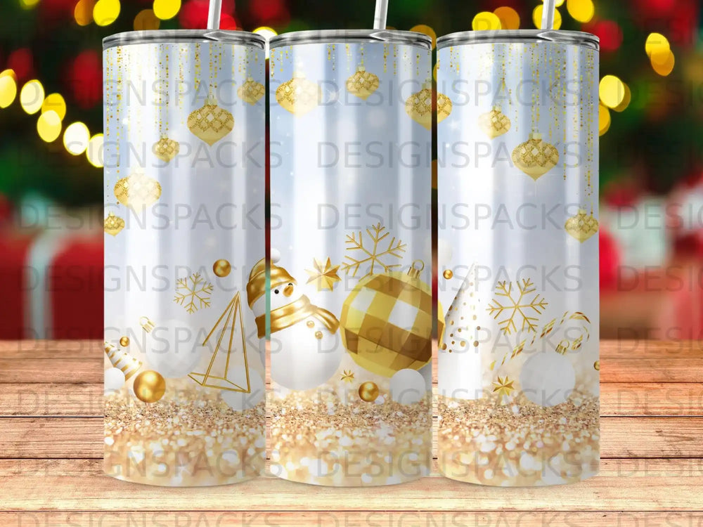 Three festive tumblers with gold glitter and snowman, snowflake, and ornament designs.