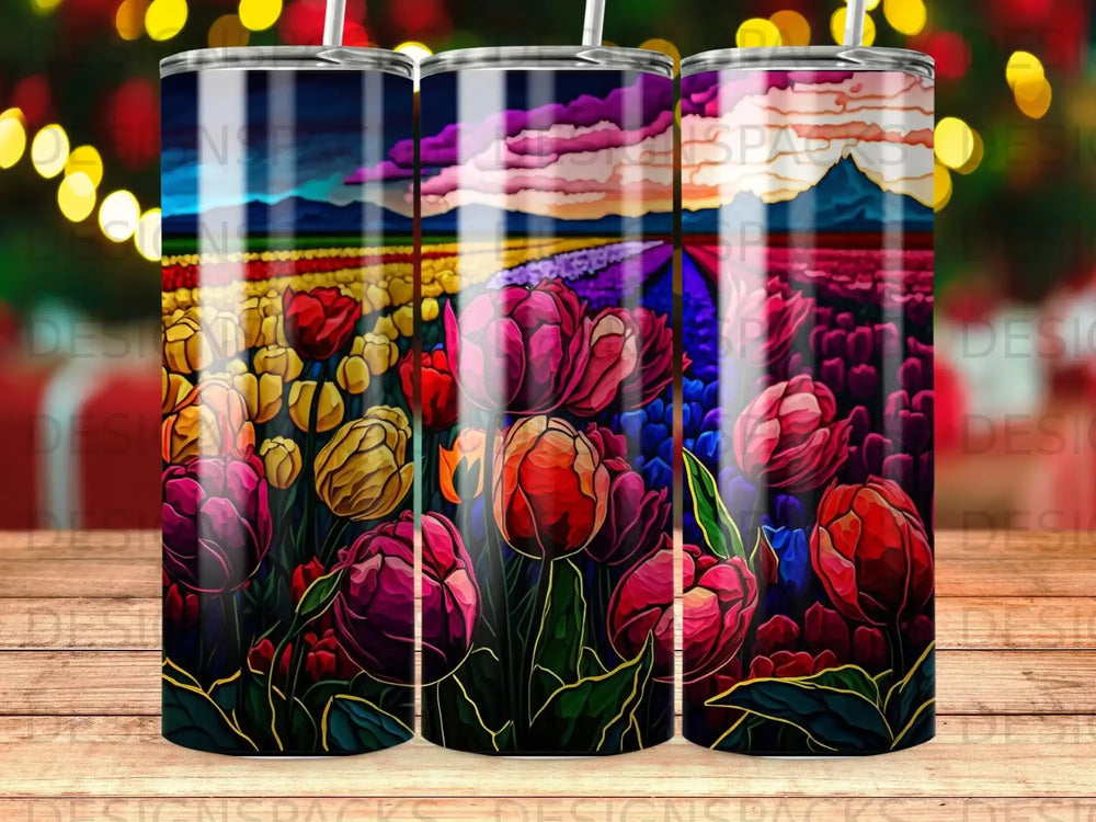Tulips in a field under a colorful sky, on a tumbler.