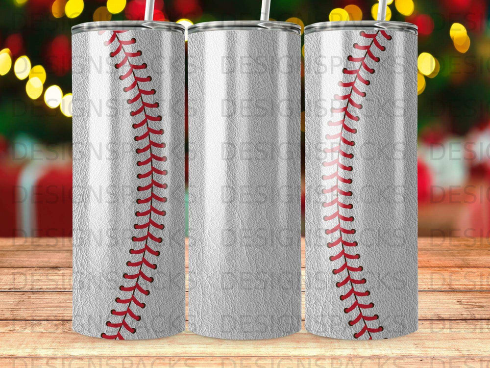 Three tumblers with a baseball stitch pattern and blurred festive lights.