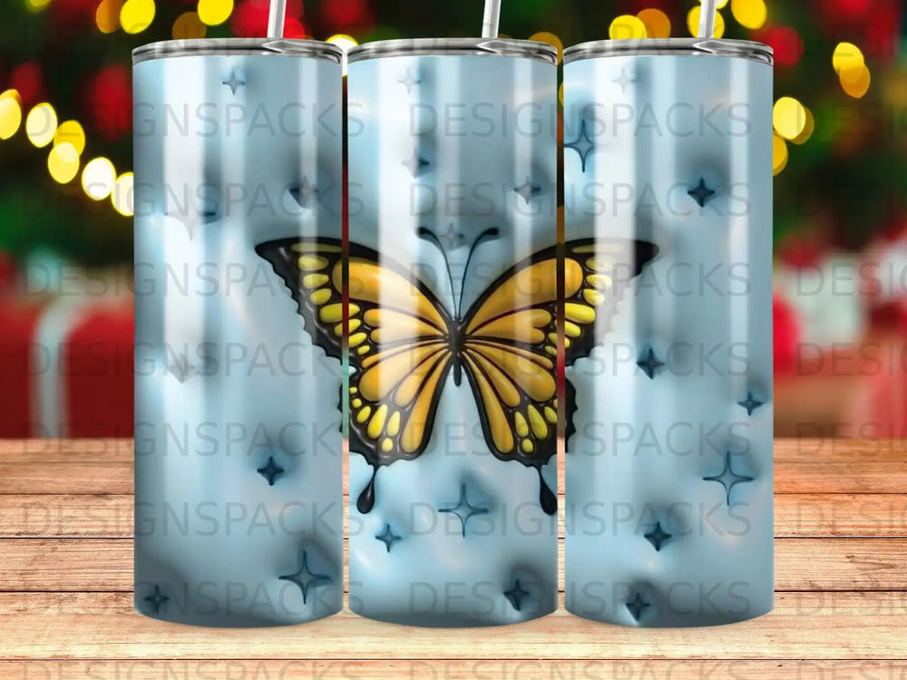 Tumbler with a prominent yellow butterfly and repeated "DESIGNSPACKS" watermark.