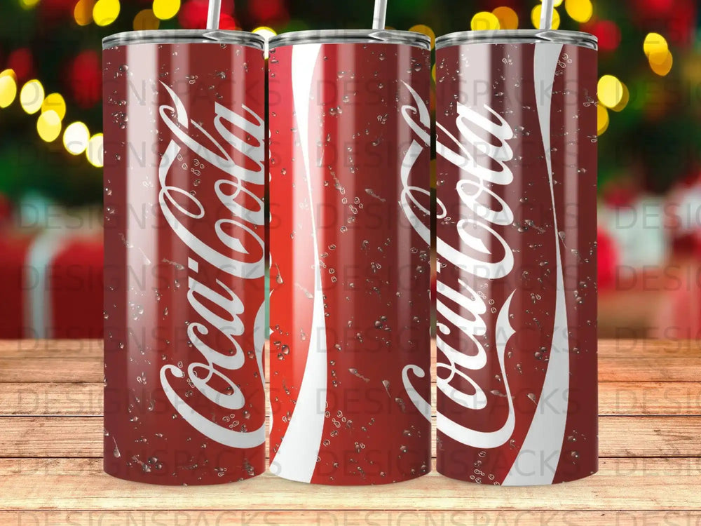 Red Coca-Cola tumbler with water droplets, against a blurred festive background.