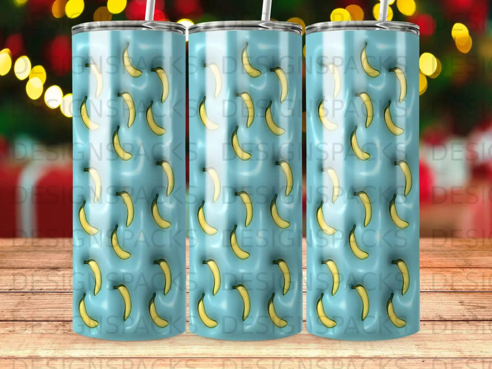Three tumblers with a repeating pattern of yellow bananas on a blue striped background.