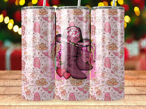 Pink tumbler with a cowboy hat, boots, hearts, and Western-themed icons.