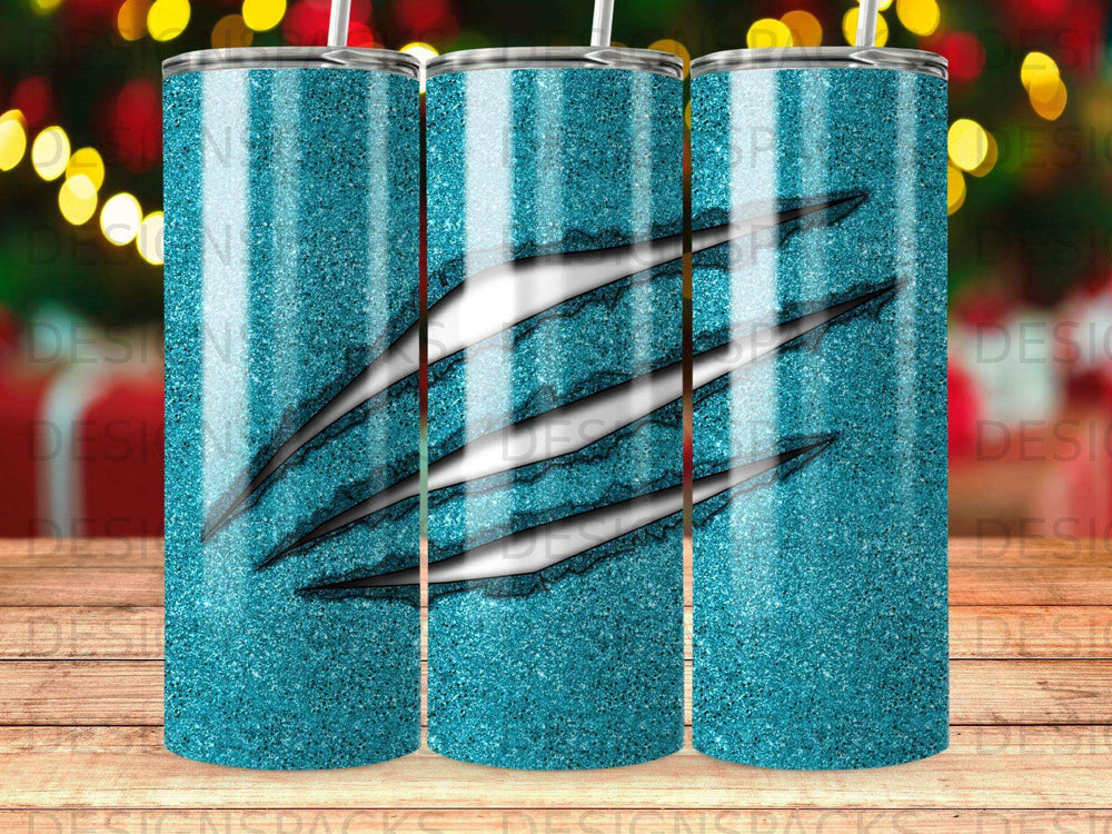 Turquoise glitter tumbler with claw marks.