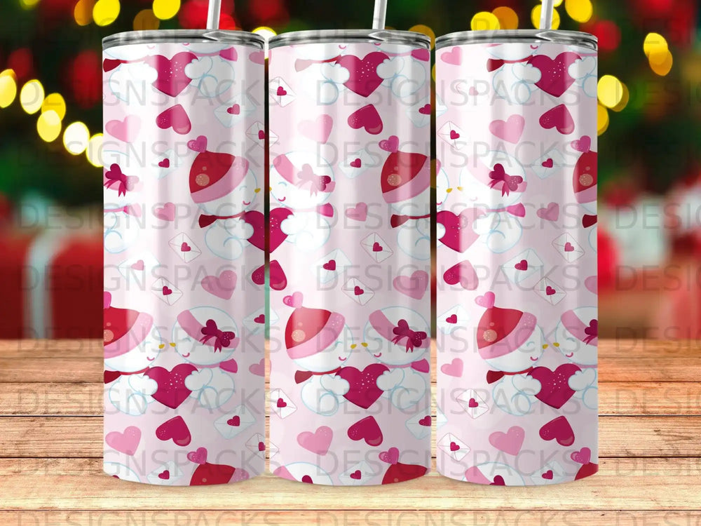 Three tumblers with pink background and scattered hearts and snowmen with Santa hats.