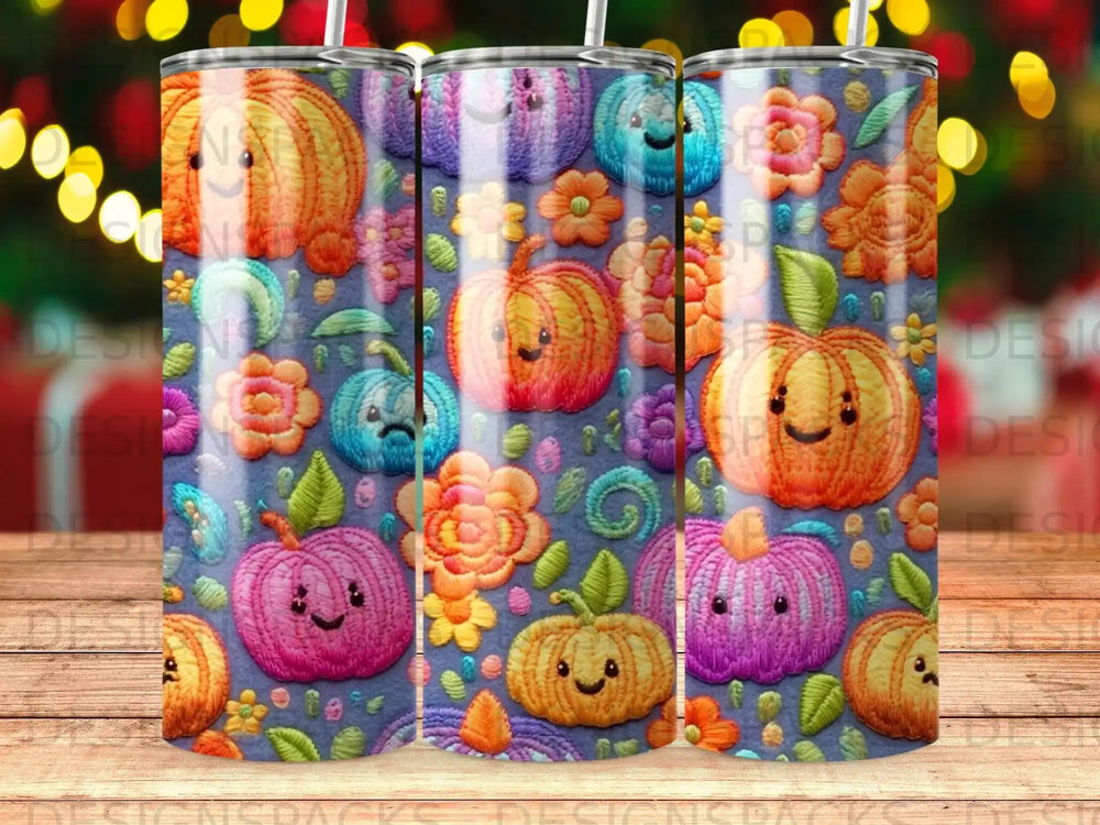 Three colorful tumblers with a pumpkin and floral embroidered pattern.