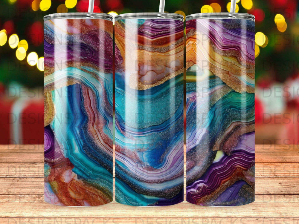 Three tumblers with colorful agate and gold marbled patterns.