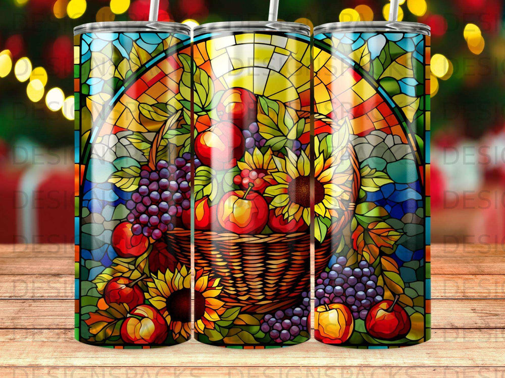 Stained glass tumbler with a basket of fruit and sunflowers.