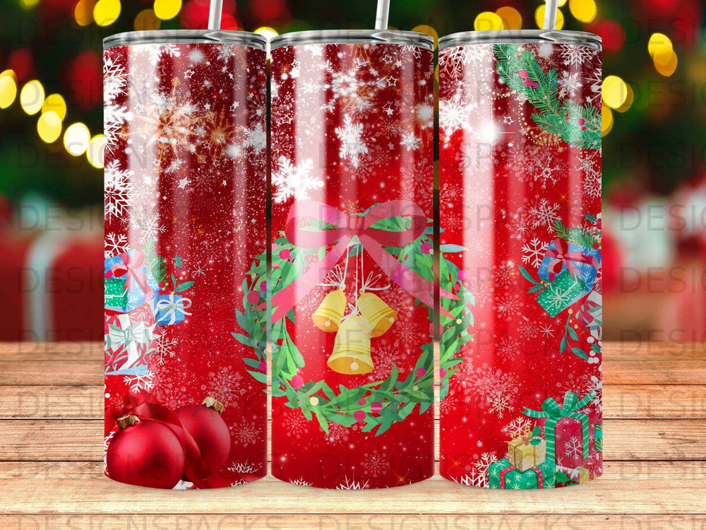 Christmas wreath with bells on a tumbler with snow and gifts.