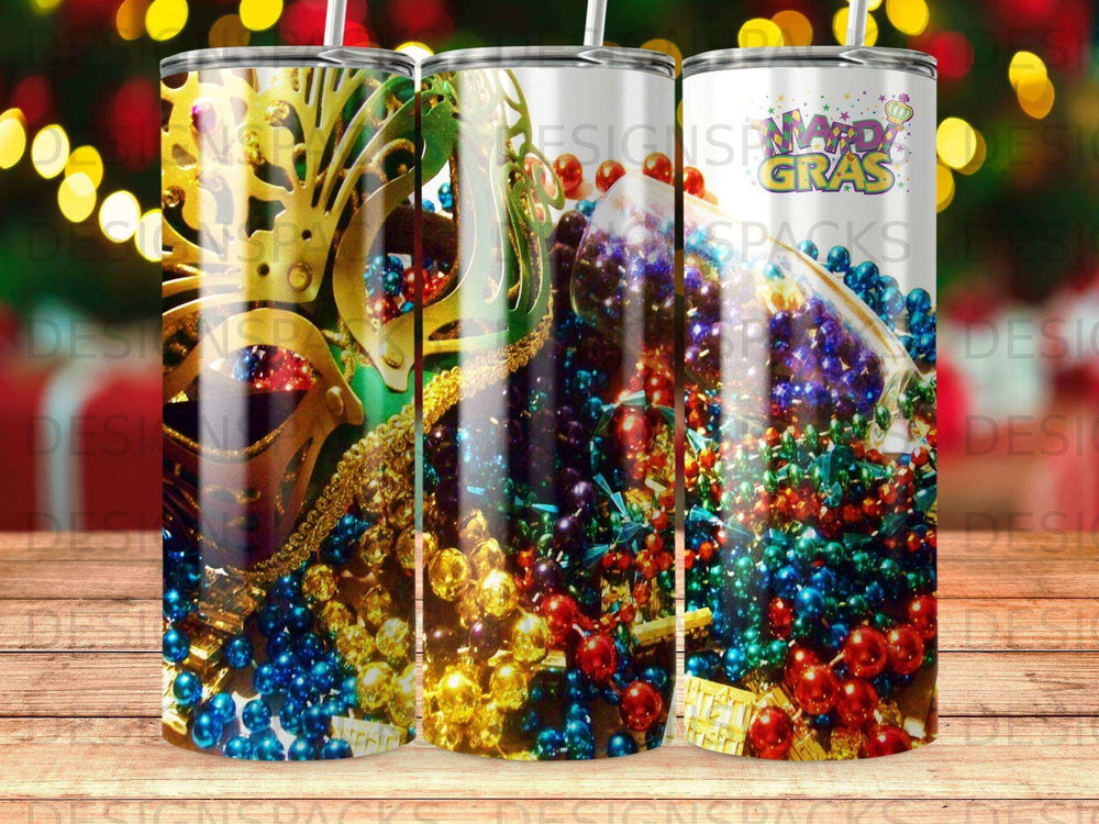 Mardi Gras beads and mask on a tumbler with bokeh lights.