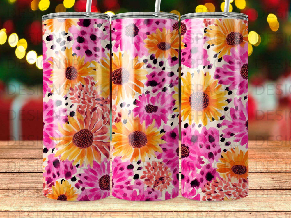 Three tumblers with a vibrant floral pattern of pink and yellow flowers.