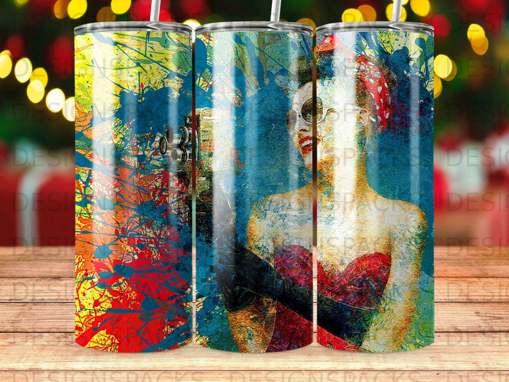 Abstract art tumbler with a stylized woman's face and vibrant splashes of color.