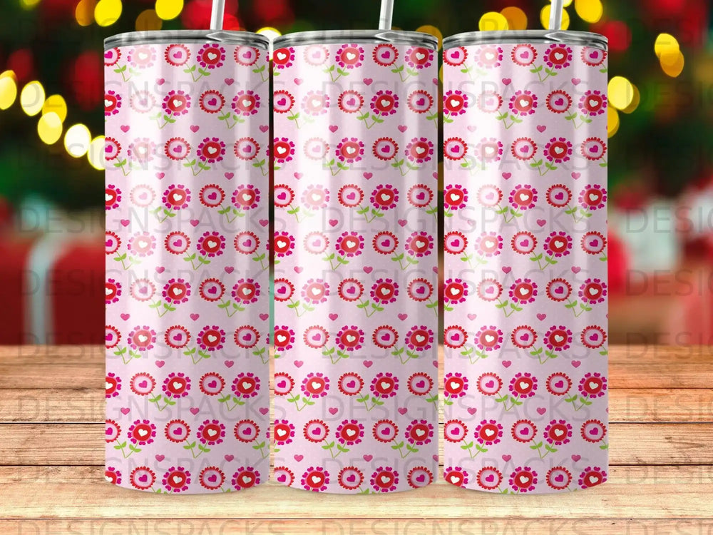 Pink tumbler with repeating pattern of small flowers and hearts.