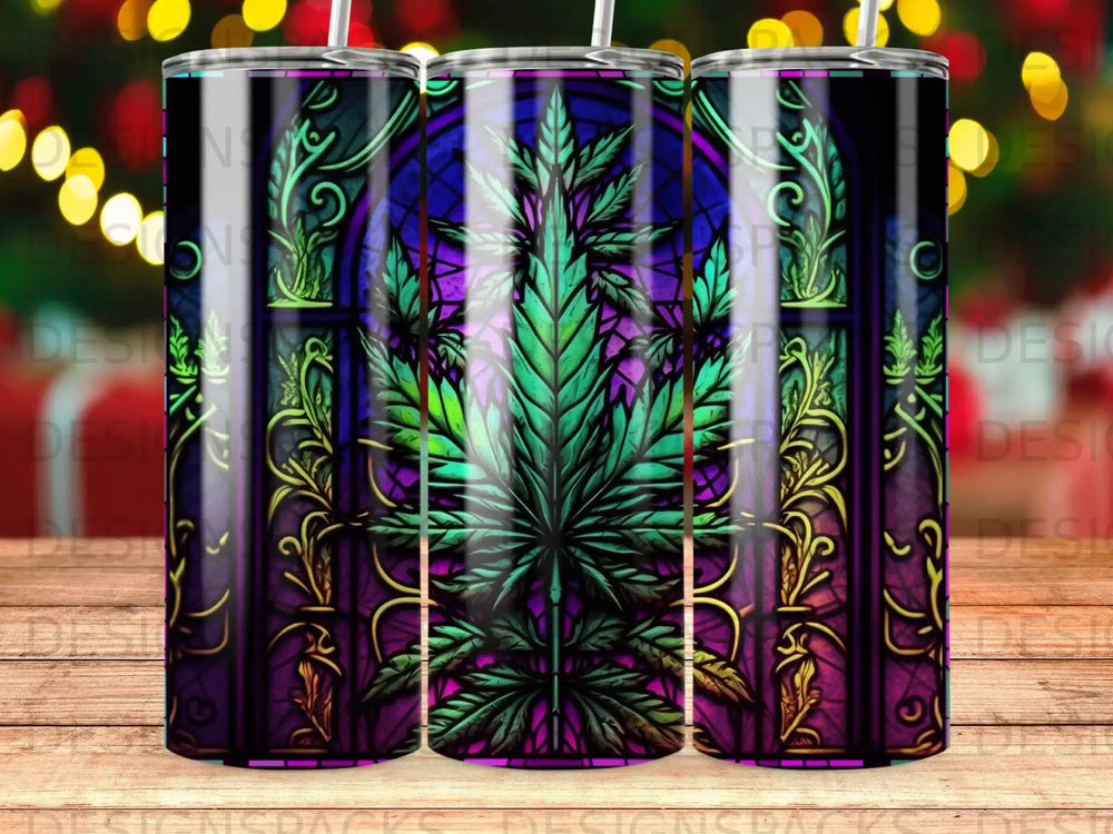 Stained glass tumbler with marijuana leaf and ornate border.