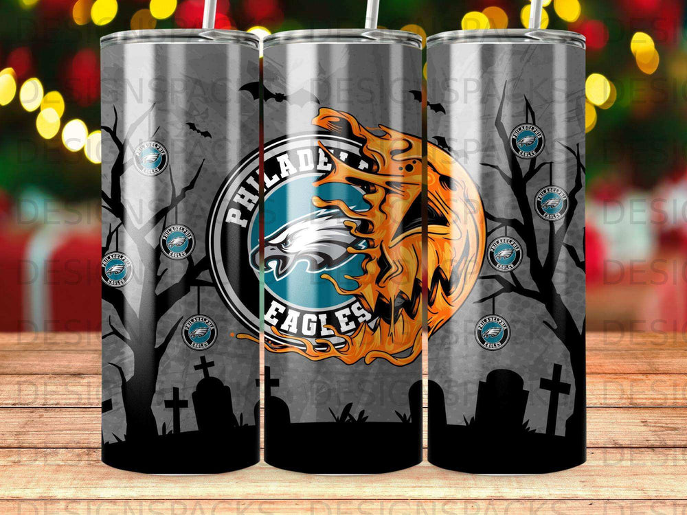 Philadelphia Eagles logo on spooky Halloween-themed tumbler with gravestones and trees.
