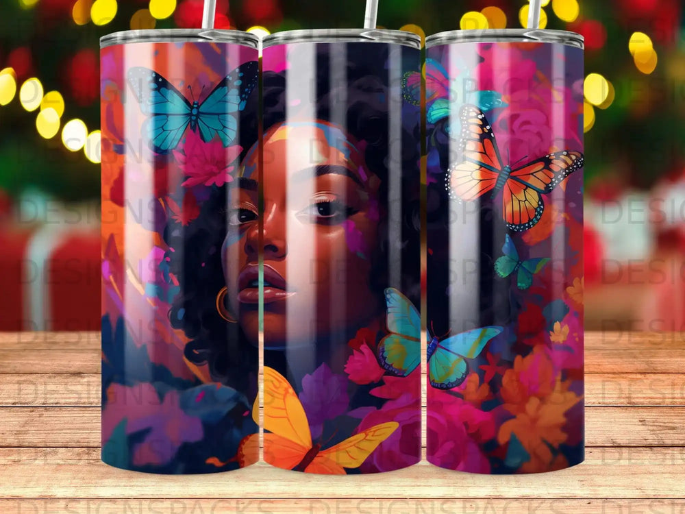 Tumbler with colorful butterflies and floral art on a woman's face.
