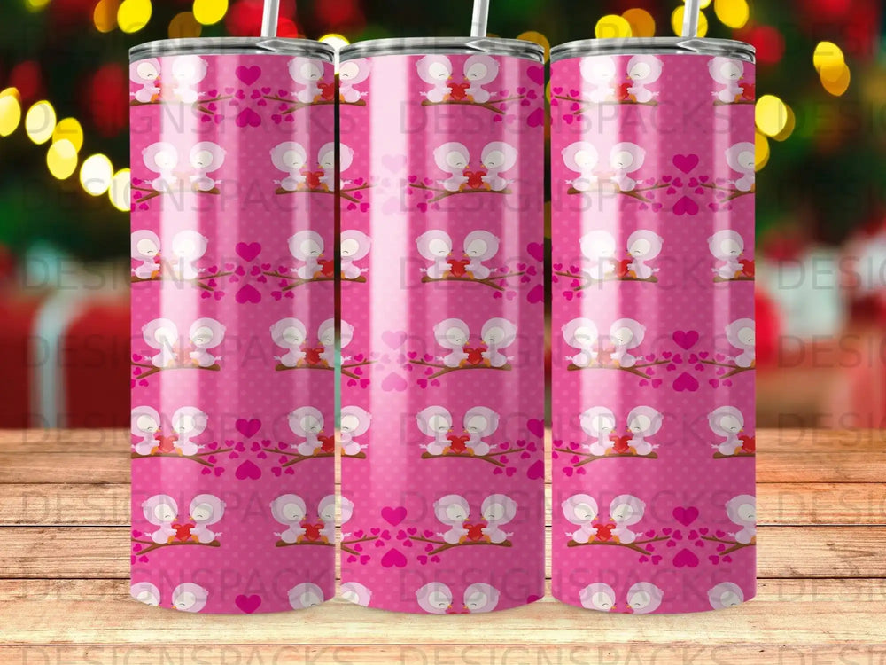 Pink tumbler with birds and hearts pattern.