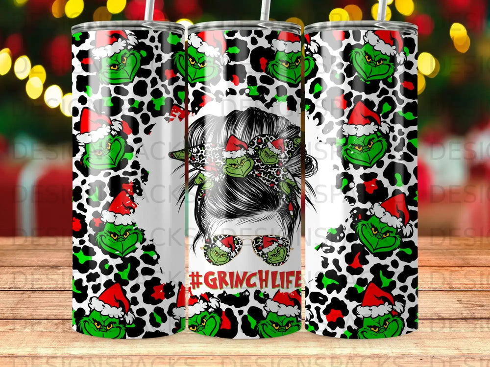 Grinch pattern tumbler with Santa hats and leopard print accents.
